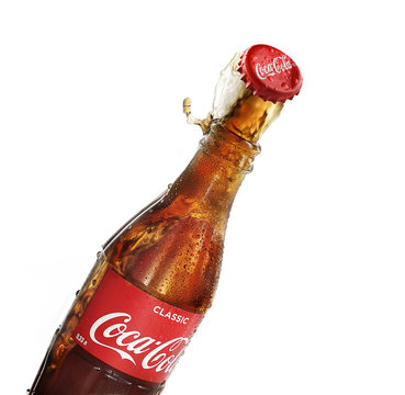POLTAVA, UKRAINE - February 10, 2018: Splash bottle coca cola on a white background.Coca-Cola is a carbonated soft drink sold in stores, throughout the world.