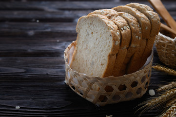 Fresh homemade  baked whole grain bread and sliced bread on wooden