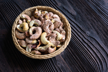 Roasted cashews on natural wooden table background