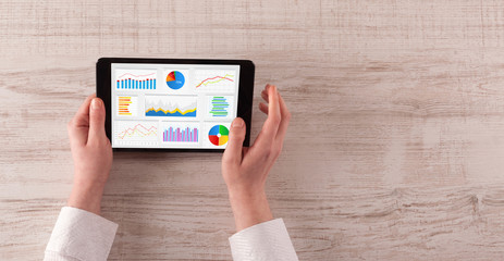 Hand making diagrams and charts on tablet