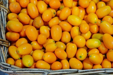 Basket of ripe orange kumquat citrus fruit