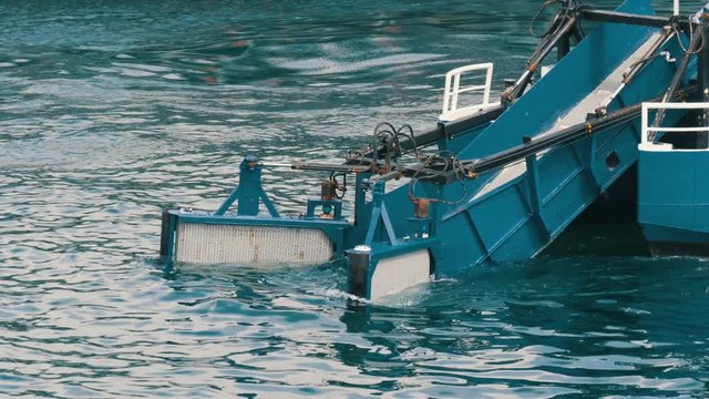 A water treatment vessel cleans the waters and trash from the water of the Sea of Marmara near the pier. Sea ship removing garbage from the water area of Istanbul