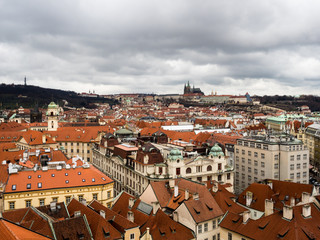 Fototapeta premium Panoramic view of Prague Old Town rooftops on a gloomy winter day - view from Old Town Hall Tower