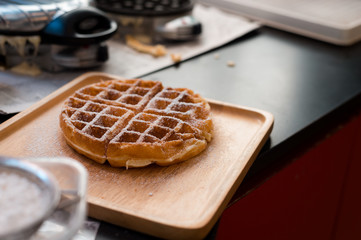 waffles with butter on wooden plate