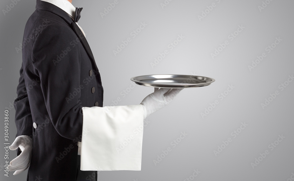 Wall mural Waiter serving with white gloves and steel tray in an empty space