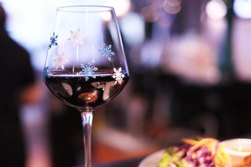 A glass of wine ornamented with snowflakes  for Christmas celebrity