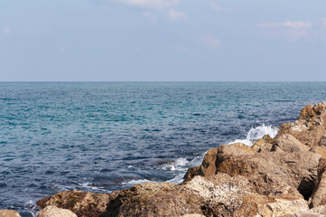 Fototapeta na wymiar Stones and blue sea water as background