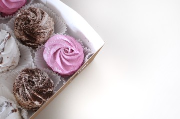 Set of homemade marshmallow zephyr in a box on white background