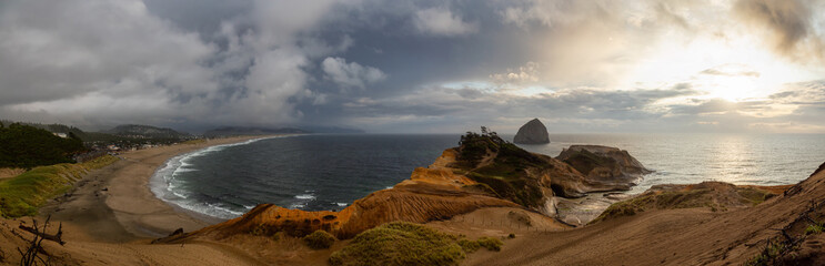 Cape Kiwanda, Pacific City, Oregon Coast, United States of America. Beautiful Panoramic Landscape View of a Sandy Shore on the Ocean during a cloudy summer sunset.