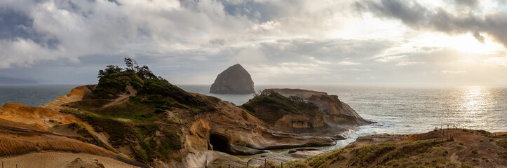 Cape Kiwanda, Pacific City, Oregon Coast, United States of America. Beautiful Panoramic Landscape View of a Sandy Shore on the Ocean during a cloudy summer sunset.