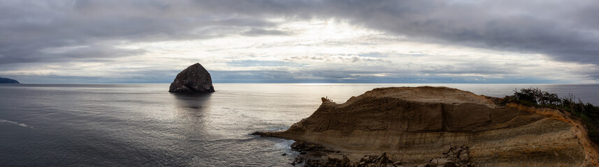 Pacific City, Oregon Coast, United States of America. Beautiful Panoramic Landscape View of a Rocky Shore on the Ocean during a cloudy summer sunset.