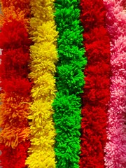 Wool Craft - Background of multicolored pom poms string arranged sideby side