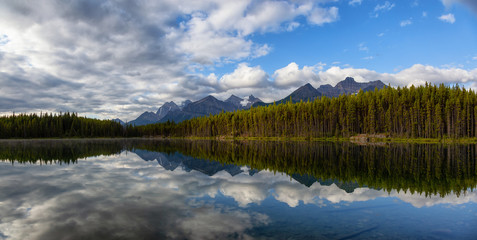 Beautiful Panoramic View of Herbert Lake surrounded by Canadian Rocky Mountain Landscape during a summer sunrise. Taken in  Banff, Alberta, Canada.
