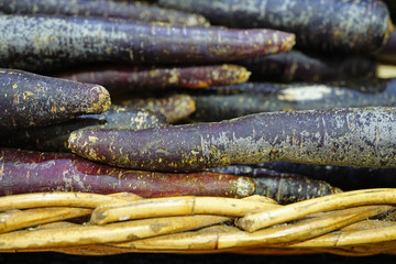 Colorful purple heirloom carrots at a farmers market