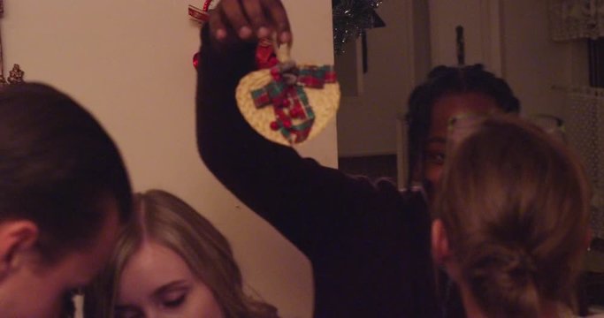 Man going around a holiday party with a mistletoe, trying to get people to kiss - shot on RED