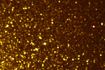 gold Sparkling Lights Festive background with texture. Abstract Christmas twinkled bright bokeh defocused and Falling stars. Winter Card or invitation	