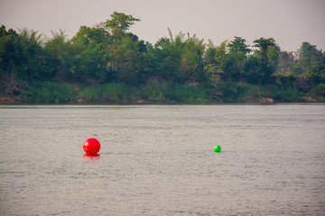 Red and green ball on the river
