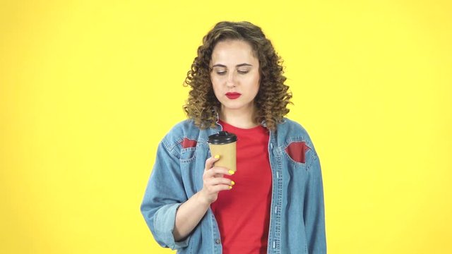 Girl drinks coffee and then feels an aversion to taste, slow motion