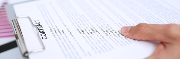 Male arm in suit offer contract form on clipboard pad