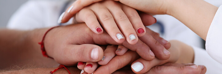 Group of doctor crossed arms in pile for win