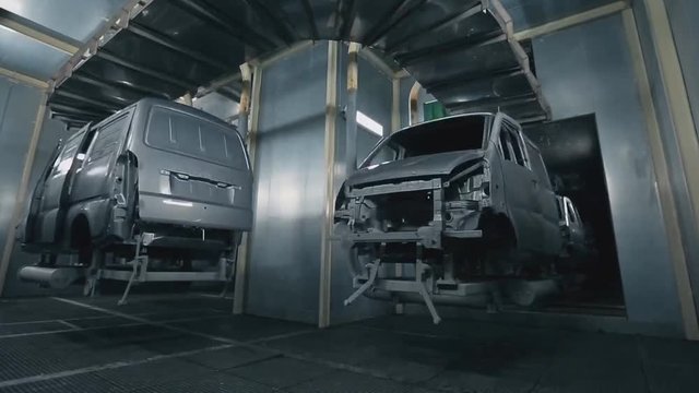 Automobile factory, industrial robots paint the car body. (time-lapse)
