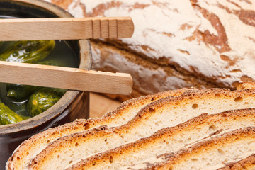 Slices of fresh baked rye or wheat bread and pickled cucumbers for breakfast