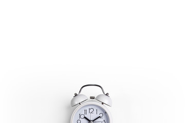 A white alarm clock on a white background. a top view. a picture with a space for writing letters