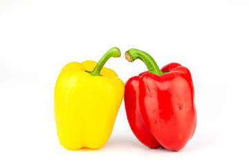 red, yellow bell peppers isolated on white background closeup