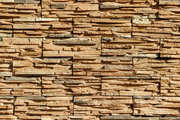 Texture of a wall made of decorative artificial stones of different sizes