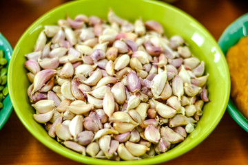 Garlic cloves in a cup of green