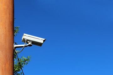 cctv security camera with record controller box on blue sky background, eye of sky