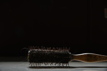  old hair brush on a black background