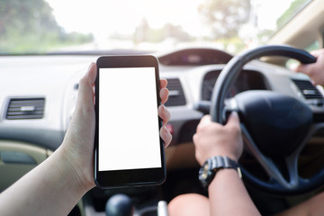 Mockup picture of business woman’s hands holding smart phone with white blank screen in modern place.