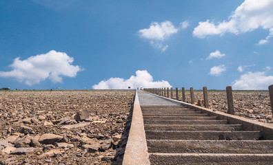 Long brick staircase with side stone have destination have bride and groom. Blue sky and white...