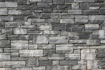 Texture of a wall made of rectangular blocks of different sizes made of natural stones