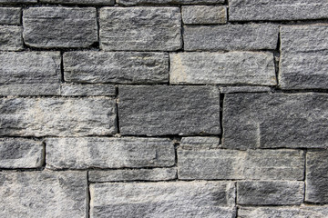 Texture of a wall made of rectangular blocks of different sizes made of natural stones