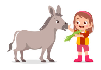 Fototapeta na wymiar happy cute kid girl feeding cute donkey