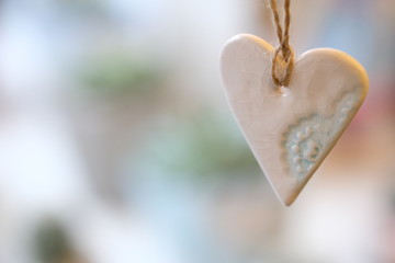 Christmas decor pink ceramic heart, ornament hanging on sacking threads