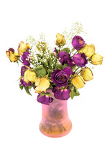 A bouquet of wilted, dry roses in a vase