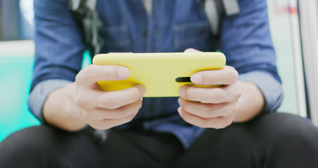 asian man play mobile game