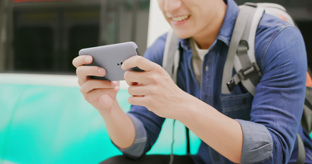 asian man play mobile game