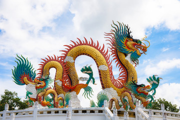 Beautiful giant or big colorful dragon statue with blue sky