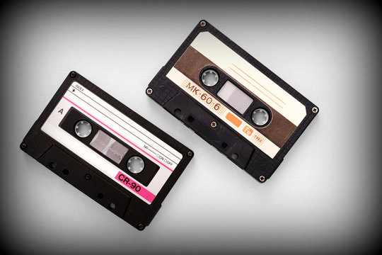 Audio tape cassettes on a gray background close-up, top view. Old Technology Concept