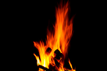 Fire texture isolated on black background. Fire flames on black background. Fire patterns. Texture of flames throughout the space. Red flames up close. The background with flames of fire..