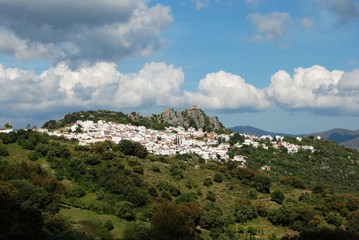 View of the white town with the castle and mountains to the rear., Gaucin, Andalusia, Spain.
