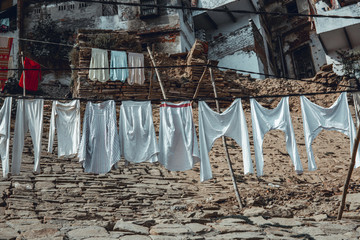 Life on the Ganges: colorful clothes drying at the sun on the steps leading to the river. Varanasi, India.