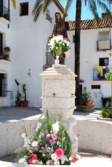 Figurine on plinth outside Santo Cristo church, Marbella, Spain.