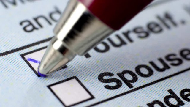 Fill in a form questionnaire. Extreme close up.