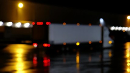 Semi truck traffic at night. Lorry delivering freight at warehouse