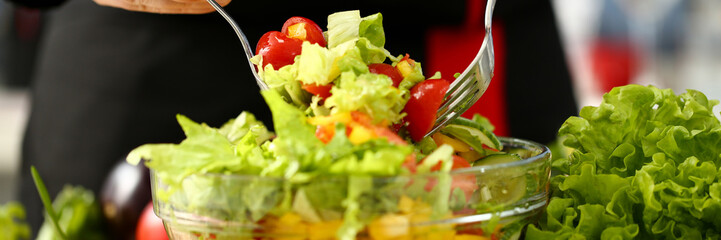 Cook holds fork in hand and mixes
